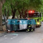 A car hit a tree and ended up on its side in the middle of 60th Street