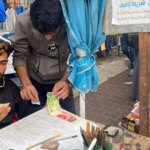 The young man who spends hours every day repairing old and torn banknotes in Gaza