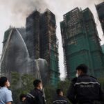 Emergency teams search for dozens of people missing in the burning building in Hong Kong international