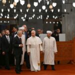 Pope Leo XIV takes off his shoes as a sign of respect as he visits a famous mosque in Türkiye during his first international trip