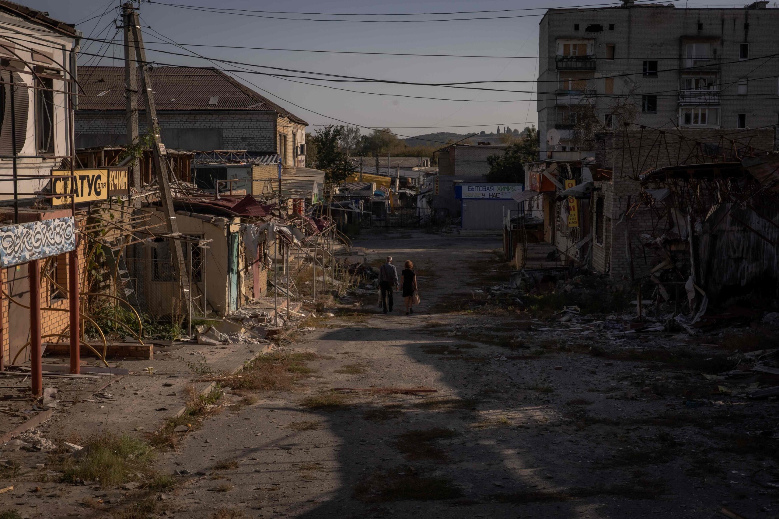 104469328-local-residents-walk-past-damaged-shops-and-buildings-in-kupiansk-kharkiv-region-on-septem.jpeg