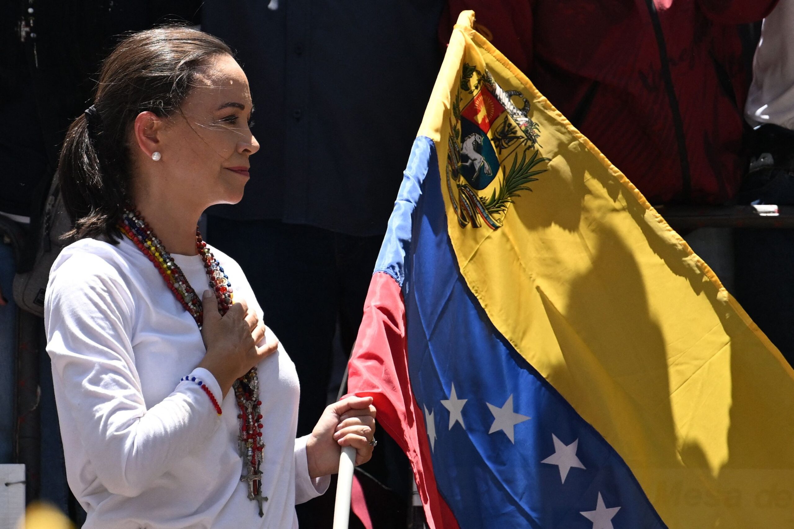 108653018-files-venezuelan-opposition-leader-maria-corina-machado-holds-a-venezuelan-national-flag-a.jpeg