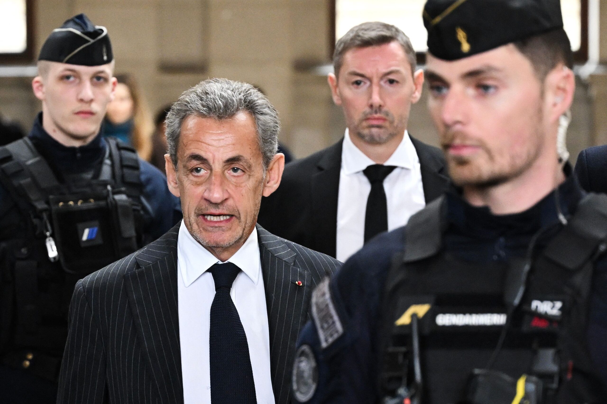 109875746-files-frances-former-president-nicolas-sarkozy-c-l-arrives-for-the-verdict-in-his-app.jpg