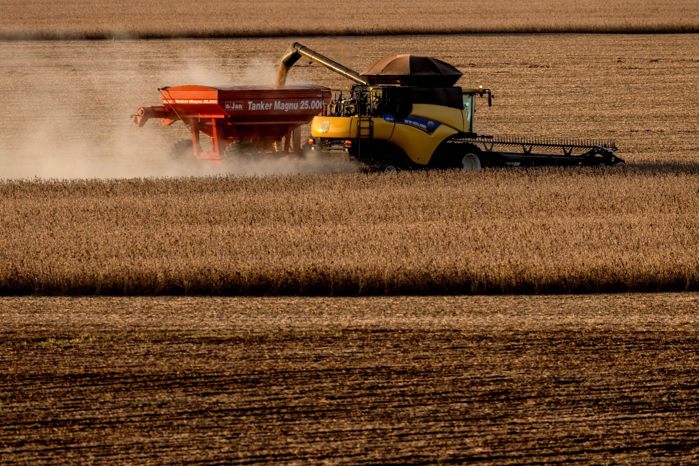 110662320-workers-use-a-combine-harvester-to-gather-soy-crops-during-a-harvest-at-a-farm-in-oriz-1.jpeg