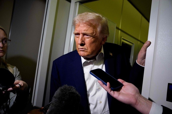 112804815-in-flight-october-24-us-president-donald-trump-takes-a-question-from-a-reporter-aboa.jpg