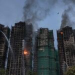 Police have arrested 13 people on suspicion of responsibility for the fire that killed 146 people in Hong Kong.