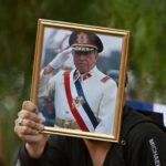 113312172-a-man-shows-a-portrait-of-the-late-chilean-dictator-1973-1990-augusto-pinochet-following-t.jpeg