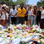 113313635-mourners-gather-by-floral-tributes-at-the-bondi-pavillion-in-memory-of-the-victims-of.jpg