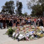 113313957-mourners-gather-by-floral-tributes-at-the-bondi-pavillion-in-memory-of-the-victims-of-a-sh.jpeg