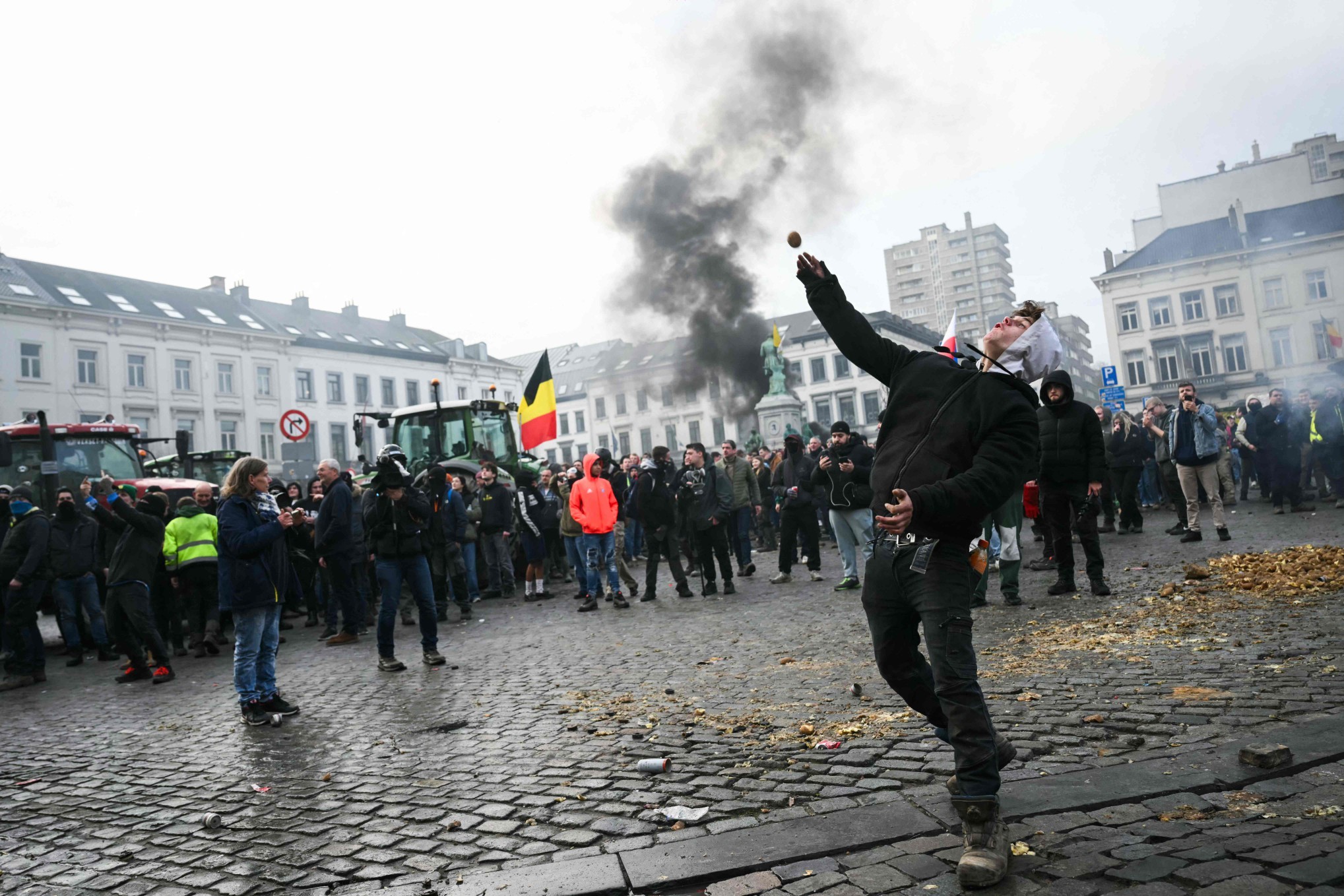 113338058-a-farmer-throws-a-potato-near-the-european-parliament-during-a-farmers-protest-to-den.jpg