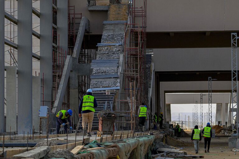 113378541-egyptian-workers-carry-out-construction-on-the-green-line-electric-express-railway-in-the.jpeg