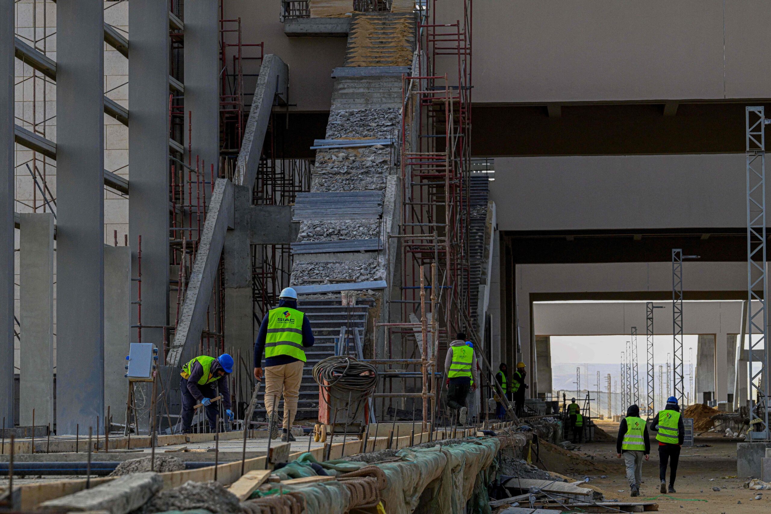 113378541-egyptian-workers-carry-out-construction-on-the-green-line-electric-express-railway-in-the.jpeg