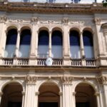 A gynecologist facing trial for sexual assault continues to work at a clinic he owns