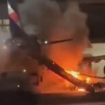 Passengers are evacuated from the plane after an equipment fire at SP Airport