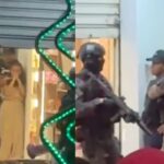 A thief was arrested after holding a woman hostage in a mobile phone store