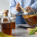 woman-preparing-kombucha-front-view.jpg