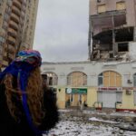 113395457-a-woman-looks-at-a-damaged-residential-building-following-russian-drones-and-missiles-atta.jpeg