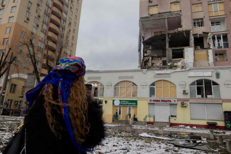 113395457-a-woman-looks-at-a-damaged-residential-building-following-russian-drones-and-missiles-atta.jpeg